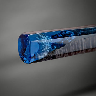 Close-up of the KAIJU Knife handle featuring a detailed Godzilla figure encased in blue resin by ITAMAE