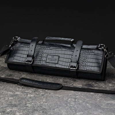 ITAMAE Tokyo Croc Knifebag closed, luxury black crocodile-textured leather knife roll with handle, straps, and shoulder strap for chefs.