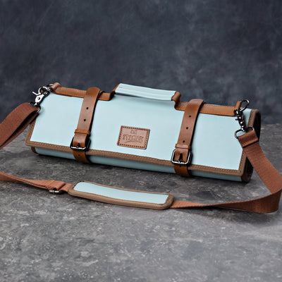 ITAMAE Ishigaki Knife Bag – premium blue and brown roll-up chef knife bag with adjustable leather straps and shoulder sling.