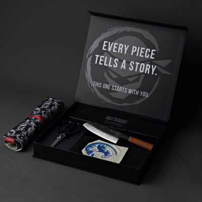 ITAMAE luxury culinary gift box featuring chef knife, apron, shears, and Japanese-inspired knife roll inside a matte black premium box.