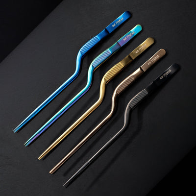 Flat lay of ITAMAE Offset Plating Tweezers with angled design for detailed food presentation and delicate plating.